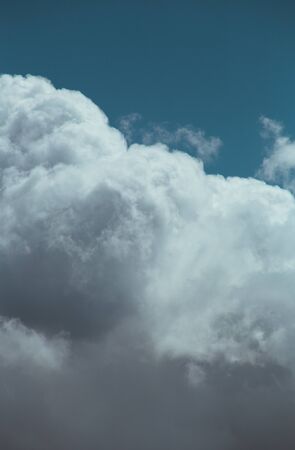 Fluffy clouds cover the summer blue skyの写真素材