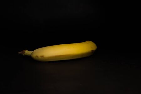 Yellow ripe banana on a black backgroundの写真素材