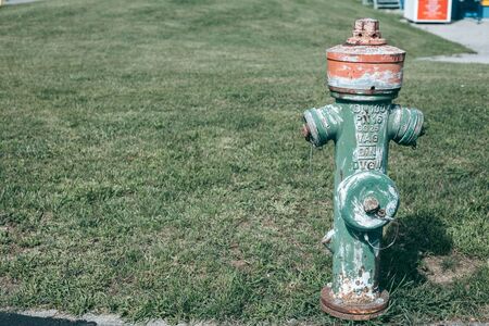 Old green fire hydrant in the cityの写真素材