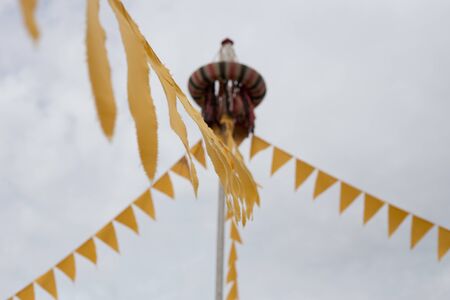 Yellow flags on a string festive on the streetの写真素材
