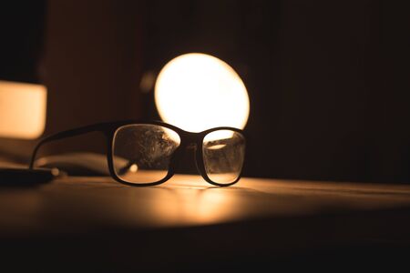 Glasses for sight and vision correction and protection from computer on the wooden tableの写真素材