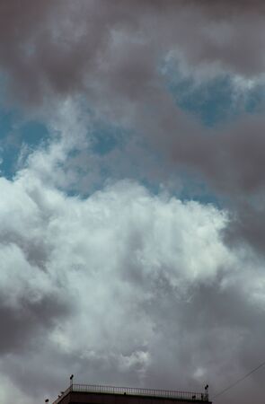 Fluffy clouds cover the summer blue skyの写真素材