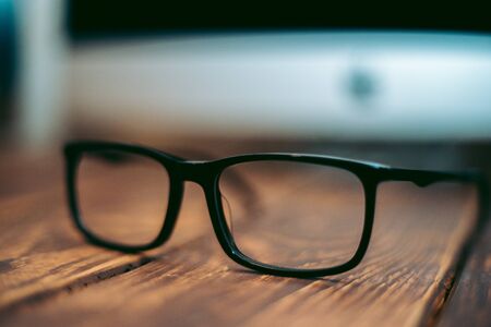 Glasses for sight and vision correction and protection from computer on the wooden table