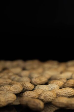 Ripe unroasted peanuts in husk and backgroundの写真素材