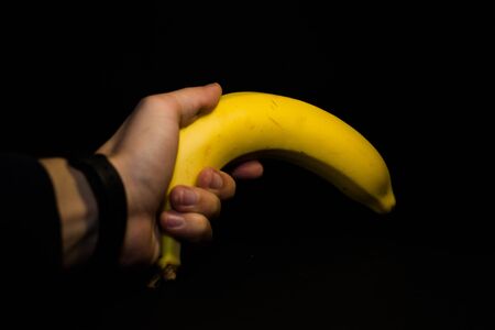 Yellow ripe banana on a black background