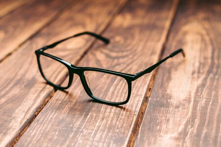 Glasses for sight and vision correction and protection from computer on the wooden tableの写真素材