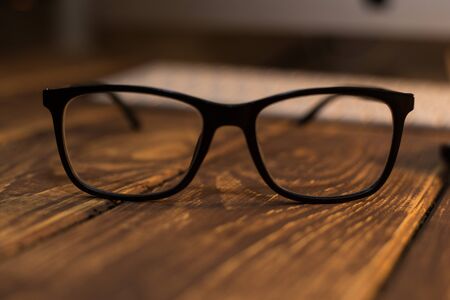 Glasses for sight and vision correction and protection from computer on the wooden tableの写真素材