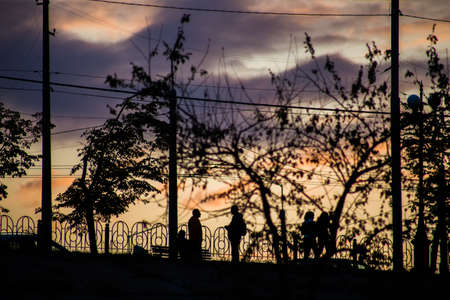 Silhouette of a man on a sunset background in the sity