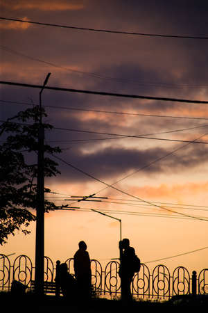 Silhouette of a man on a sunset background in the sityの写真素材