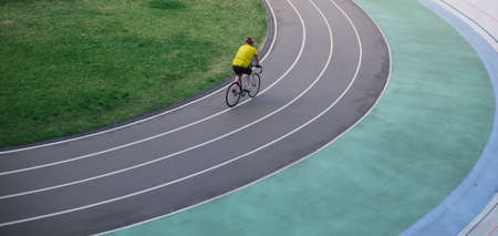 A man rides a bicycle on a track stadiumの写真素材