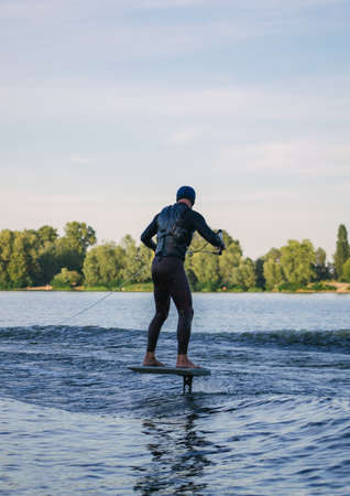 Man on a wakeboard in the river at daytimeの写真素材