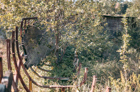 Old abandoned wooden bobsleigh track in summer by daylight
