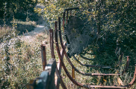 Old abandoned wooden bobsleigh track in summer by daylight
