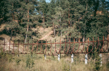 Old abandoned wooden bobsleigh track in summer by daylight