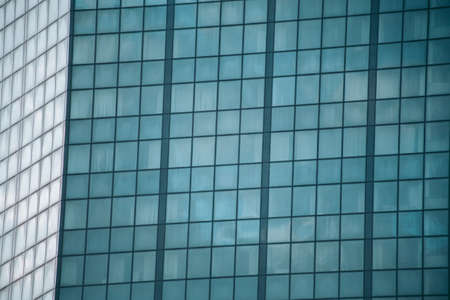 Glass windows of an office building in a modern city in the financial districtの写真素材
