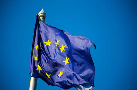 European union flag fluttering against blue sky
