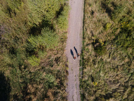 Aerial view of two people on the road in the fieldの写真素材