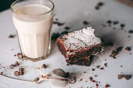 Freshly baked aromatic homemade cakes with a glass of milkの写真素材