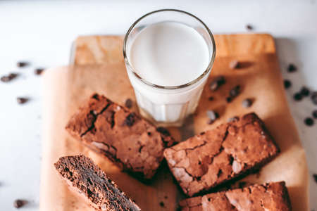 Freshly baked aromatic homemade cakes with a glass of milkの写真素材