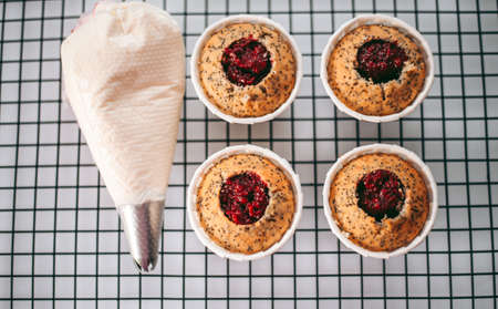 Delicious appetizing fresh baked muffins in the kitchen close up