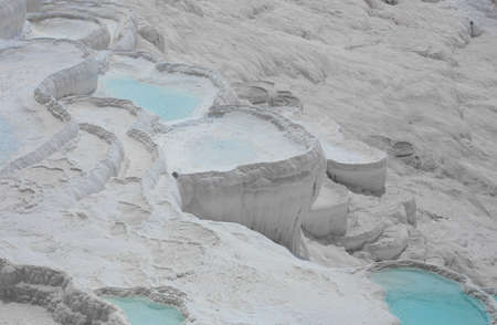 Carbonate mineral cliff with calcite-laden waters in Hierapolis Pamukkale in Turkey. Pamukkale is...
