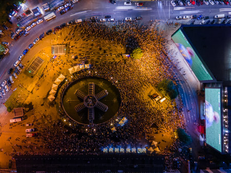 Kyiv, Ukraine 06/30/2020: A large group of fans in the square near large screens with the broadcast of the football match for Euro 2020 between Ukraine and Sweden near Guliver mallのeditorial素材