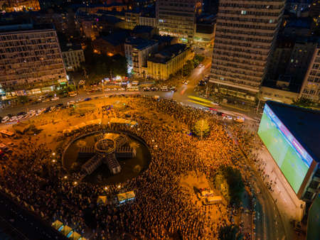 Kyiv, Ukraine 06/30/2020: A large group of fans in the square near large screens with the broadcast...