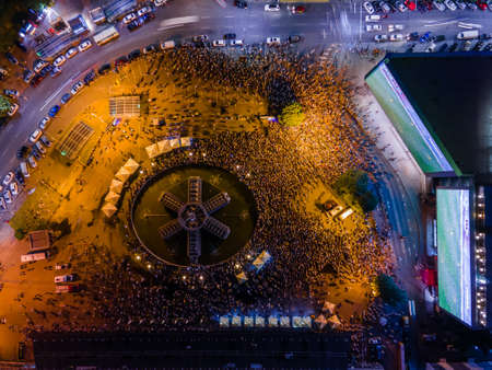 Kyiv, Ukraine 06/30/2020: A large group of fans in the square near large screens with the broadcast of the football match for Euro 2020 between Ukraine and Sweden near Guliver mallのeditorial素材