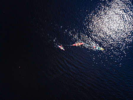 Aerial view from a drone of a person who floats on a sup in the waterの写真素材
