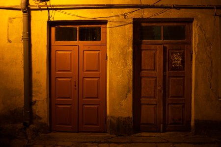 Two wooden doors at night on the streetの写真素材