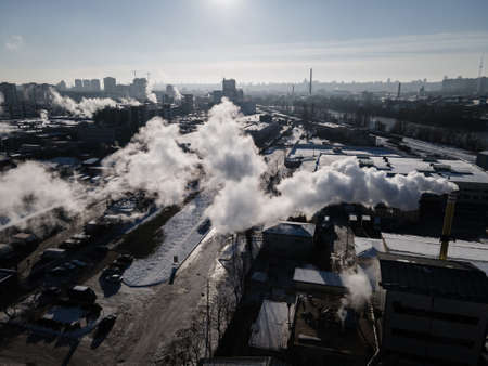 Aerial view from a drone to the factory and to air pollution in the cityの写真素材