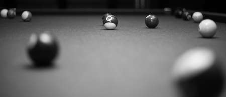 Billiard table in the billiard room with balls and cue