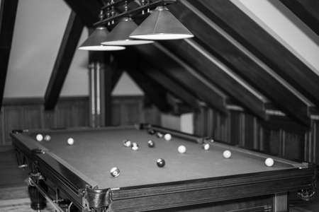 Billiard table in the billiard room with balls and cue