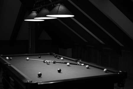 Billiard table in the billiard room with balls and cueの写真素材