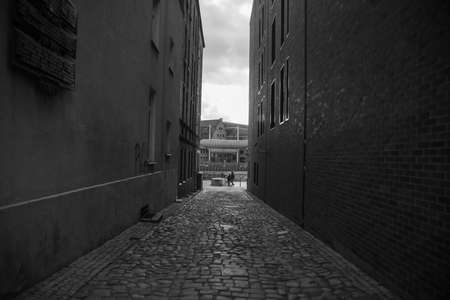 Narrow street in Europe in Stockholm without people during the day with a paved road