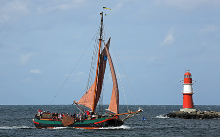 PORT WARNEMUENDE, GERMANY - AUGUST 09  Old dutch sailing ship DE ALBERTHA is passing the light beacon on August 09, 2014 in the scope of the 24th Hanse-Sail at the port Rostock-Warnemuende - Mecklenburg-Vorpommern, Germany  のeditorial素材