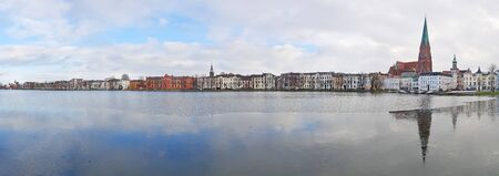 Eastside of Pfaffenteich in Schwerin, Mecklenburg-West Pomerania, Germany - panoramic view in winter timeの写真素材