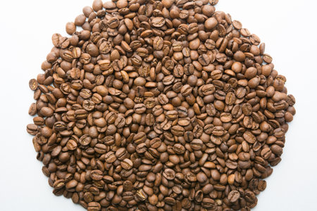 Roasted coffee beans pile isolated on white background.