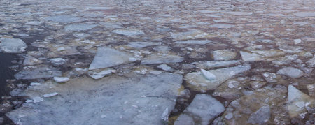 Cracked ice, lots of pieces of ice on the river in spring
