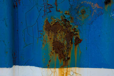 Rusted blue painted metal wall.