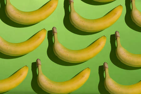 Seamless bananas pattern. Creative yellow bananas pattern on green background.の写真素材