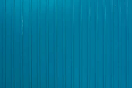 Corrugated wall made of blue metal. Texture of corrugated wall made of blue metal.