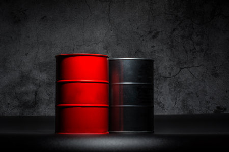Red and metall barrel of oil on a black background for design.