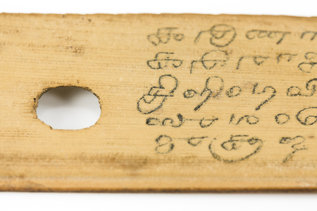 detail of a preserved palm leaf (borassus flabellifer) manuscripts showing writings about ayurvedic medicines in old malayalam script from Kerala, Indiaの写真素材