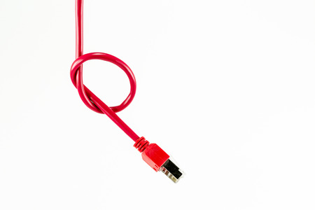 red patch cable with RJ45 connector and knotの写真素材