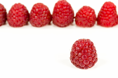 fresh red raspberries isolated on white background