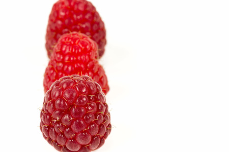 fresh red raspberries isolated on white background