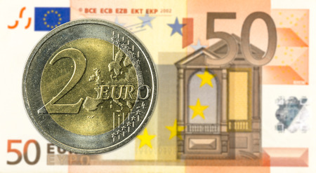5 euro coins against 50 euro bank note obverseのeditorial素材