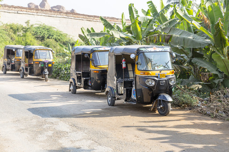auto rickshaws waiting in line, tuk-tuk on the road, Hampi, Karnataka, India