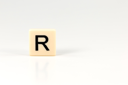 capital letter R on plastic board isolated on white background with copy space